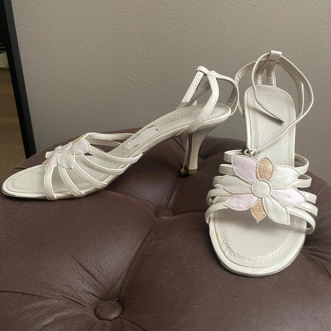 Beige sandaler med klack och blomdetalj