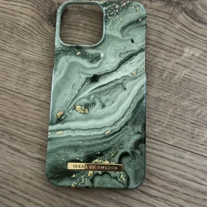 Grön marmor mobilskal Ideal of Sweden - Snyggt mobilskal från Ideal of Sweden med grön marmorerad design och gulddetaljer. Skalet har en lyxig känsla och passar perfekt för dig som vill ha något unikt till mobilen. Märkeslogga i guld framtill.
