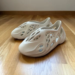 Adidastofflor Yeezy Foam RNNR stl 43 - Säljer ett par Adidas Yeezy Foam Runner i beige. Väldigt bekväma! Använda en sommar, men i bra skick, endast lite slitage på sulorna (se bild). 