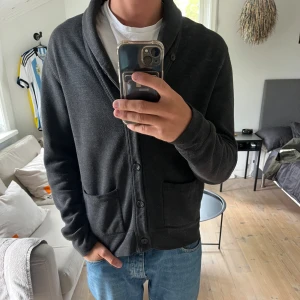 Ralph Lauren Mörkgrå kofta / cardigan - Säljer nu min Mörkgrå kofta från Polo Ralph Lauren. Fint skick då den är sparsamt använd.