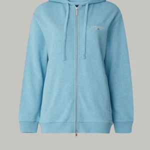 Ljusblå Lexington hoodie med dragkedja - Säljer en ljusblå hoodie från Lexington i storlek XS. Tröjan har huva med snörning, hel dragkedja framtill och ribbade muddar. Mjuk bomullskänsla och diskret Lexington-logga på bröstet. 