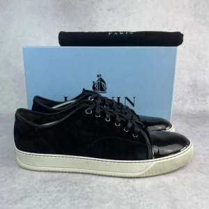 Lanvin DBB1 cap toe sneaker - – Condition: 9/10  – Size: UK12  – What is included: Dustbag  – Retail price: 6400 SEK  This model fits big, our recommendation would be to go down one size from your normal one.