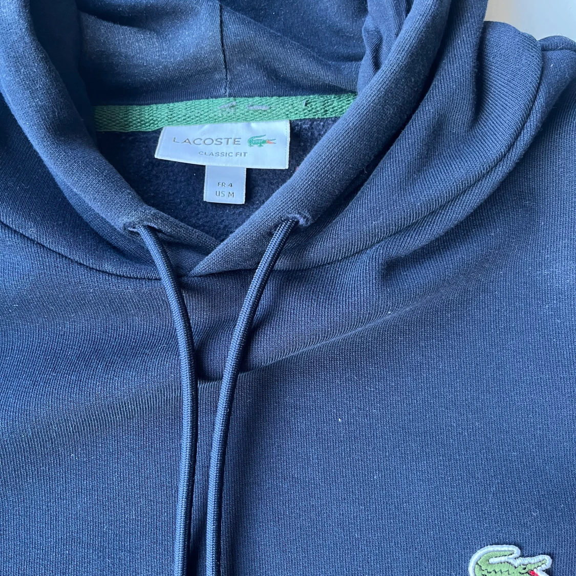 Marinblå hoodie från Lacoste - 1