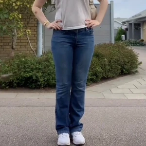 lågmidjade bootcut jeans  - Säljer ett par klassiska blå jeans från 4Wards med bootcut-passform. Jeansen har fem fickor, låg midja och snygga kontrastsömmar. Perfekta för dig som gillar en tidlös denimlook.