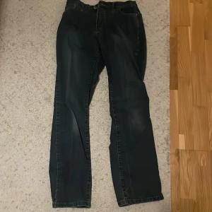 Svarta jeansbyxor - Snygga svarta jeansbyxor med klassisk femficksdesign. De har en rak passform och är perfekta för en avslappnad stil. Byxorna har en dragkedja och knapp framtill.