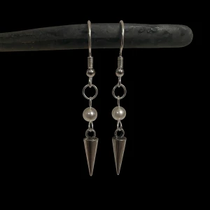 Silvriga örhängen med pärlor och spikes - Coola silvriga örhängen med kedjedetaljer, vita pärlor och spetsiga spikes längst ner. Ej nickel eller rostfritt! 