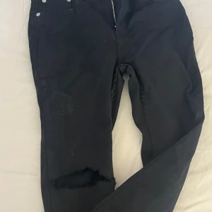 svarta skinny jeans med hål - har aldrig använt dom alls därför är lappen kvar men jag har klippt hål i knäna och längst ner. 