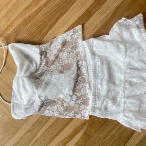 Vit spets bandeau tubtopp med knyt plus en kjol - Vitt spets sett, men topp som har öppen rygg och en kjol 