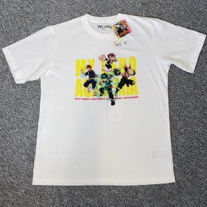 My Hero Academia t-shirt från Uniqlo - Vit t-shirt från Uniqlo med My Hero Academia-tryck framtill. Helt ny med laparna kvar på. Hör av dig vid frågor eller funderingar!