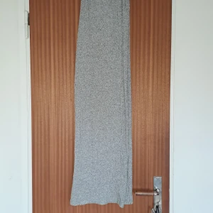 Grå ribbad byxsa från 157 - Mysig grå Byxor från 157 i ribbat stickat material. Byxan har en rak passform och elastisk midja som gör den bekväm och enkel att bära. Perfekt för dig som gillar en chill och stilren look.