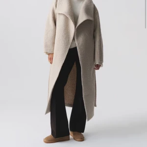 Soft boucle long coat gina tricot - Lång kappa från gina tricot i boucle med knyte i midjan. Denna är supervarm, använde som höst/tidig vinterjacka förra året men kom bara till användning någon enstaka gång. Finns inte i butik nu. 