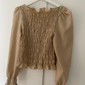 Beige blus från HM - Superfin veckad topp/ blus från hm. Superstretchig och i gott skick