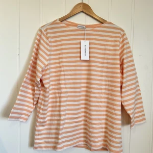 Marimekko tröja XXL - Oanvänd Marimekko tröja i perfekt skick med etiketten kvar. Vit/laxrosa randig tröja med trekvarts ärm, storlek XXL.