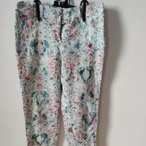 Flowery pattern trousers, coloured, in very good shape.