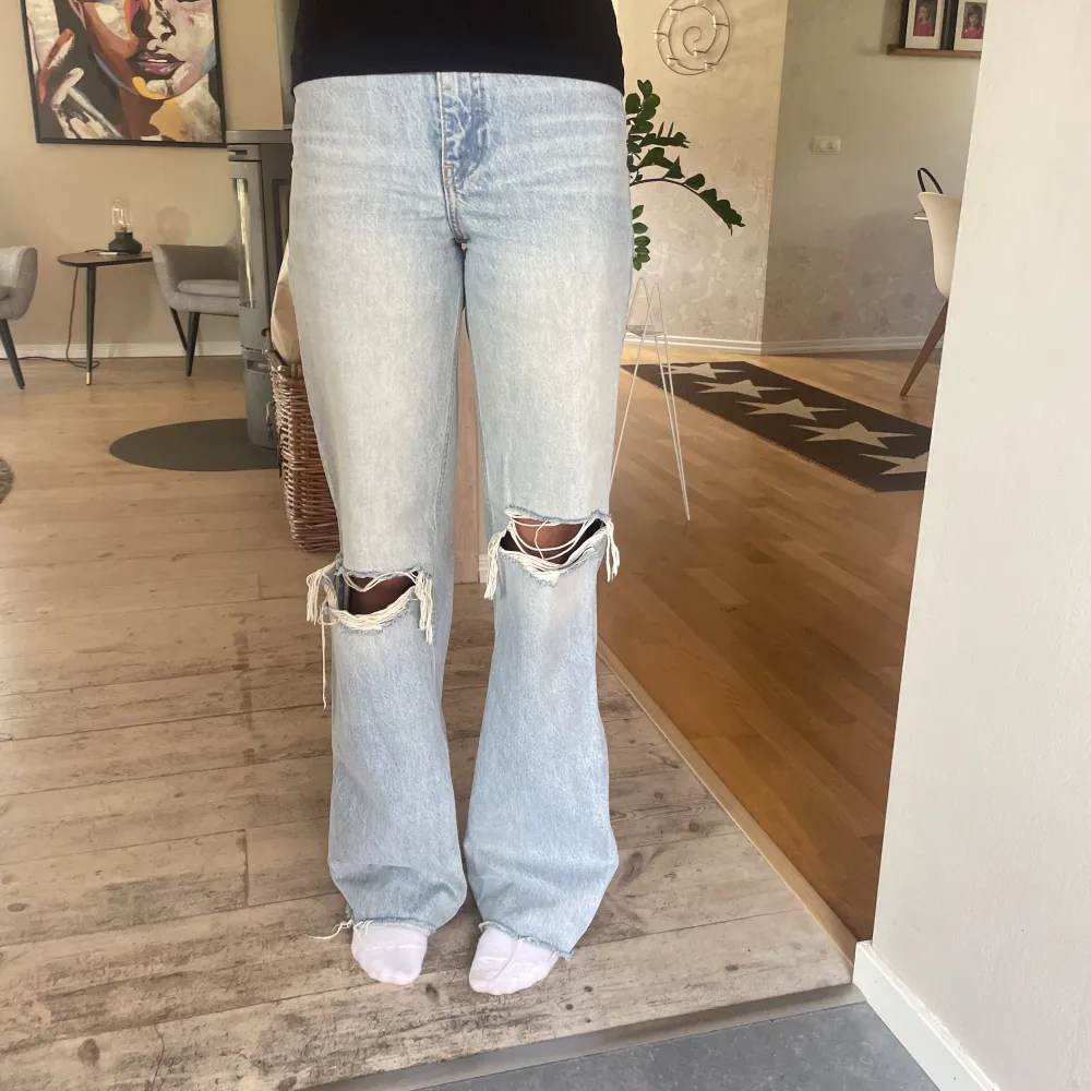 Säljer nu dessa högmidjade bootcut jeans från zara med hål i båda knäna. De har används mycket så de är lite slitna längst ner. . Jeans & Byxor.