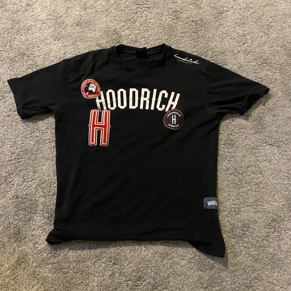Nu säljer jag min Hoodrich t shirt för har ingen användning av den längre, Den är i bra skick förutom att den har ett litet hål vid axeln som man kan se på tredje bilden, var inte rädd att skriva frågor! Skulle kunna tänka mig att sänka priset😊. T-shirts.