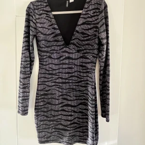 Så cool glittrig klänning - En tight lite kortare klänning i svart med glitter. Så fin och passar perfekt till nyår och eller ute. 