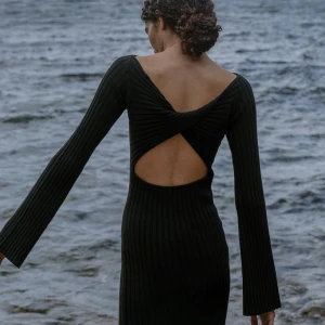 Stickad långklänning  - Stickad långklänning med fin öppen detalj i ryggen. I storlek XS