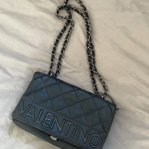 Valentino väska  - Jättefin och rymlig väska som man kan bära antingen på axeln eller cross body. Matchar till allt då den är hel svart 😌