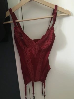 Vinröd korsett topp - Jättesöt korsett topp från märket abecita. Byststorleken är 75 B och resten skulle jag säga motsvarar en S. Toppen är aldrig använd då bysten är lite stor för mig 🥹