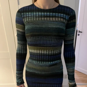 Klänning från Nelly  - Klänning från Nelly köpt för ca 1 år sedan här på Plick. Supersnygg och sitter väldigt fint på kroppen men den är nu för kort för mig som är 172 cm. Sitter tajt vid kragen. Köptes för 399.