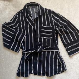 En fin svartvit-randig kimonoskjorta från MONKI med tillhörande knyte. Vida ärmar. Använd fåtal gånger! 