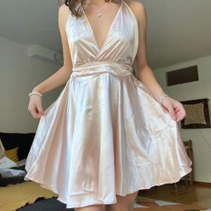 Säljer denna fina klänning i satin🤩 lite rosa/beige i färgen! Inte genomskinlig 💗 den har både dragkedja och knytning baktill och är öppen i ryggen💗