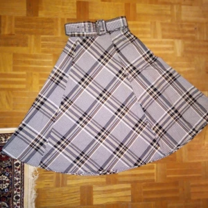 Kjol med bälte - Rutig kjol med matchande bälte. Stl 34.  Skickas mot frakt.