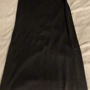 Lång svart kjol med en zip på varje sida så man kan välja om man vill ha slit på båda sidorna eller en eller ingen. Prislappen är kvar och den är köpt från Obeject för 400kr