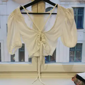 Broderie anglaise top with open back detail and puff sleeves. Cropped. Can send a picture while wearing, upon request. 