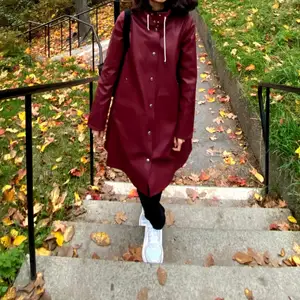 New Stutterheim Raincoat without any harm. I only wore it twice.  The color is burgundy and it is made of waterproof fabric.