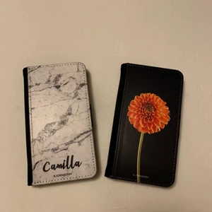 Plånboksskal från Björnberry  - Två plånboksskal från Björnberry. Fint använt skick. Det svarta med blomman är endast använt någon enstaka gång. Passar till iPhone6 / 6S, 7, 8 och SE.  50kr för Camilla skalet och 100kr för det med blomman. Eller båda för 120kr. Köparen står för frakten:)