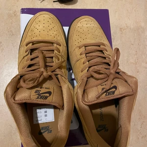 Nike sb dunk low ”wheat” bruna  - Helt nya, oanvända. Storlek US 11,5 dvs 45 har inget kvitto men en retur sedel från företaget dom köpte dom ifrån. 