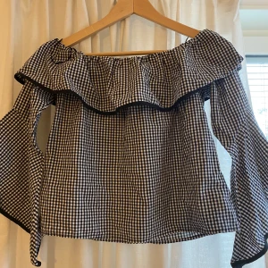 Rutig blus - Svart vit rutig offshoulder blus. Använt runt 4 gånger