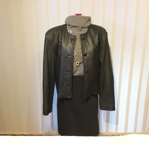 Skinn jacka - Kort jacka i shell läder. Lädret som åldras med värdighet. Breda axlar. Längd 60 cm, ärmlängd 63 cm. Från axel till acel 45 cm tar swish