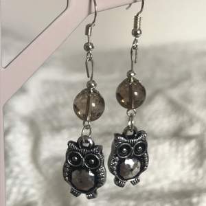 these are super cool earrings with lil owls on them with an addition of a smokey quartz which is a stone that gets rid of depression and fear!