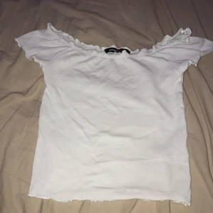  Vit tröja Gina Tricot!  - Vit tröja från Gina Tricot. Har lite volang, se bilderna. Lite kortare i modellen. Går att ha som vanligt men går även att dra ner vid axlarna. Inte mycket använd. Frakt ingår! 