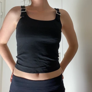 Linne från &otherstories - Svart linne från &otherstories. Perfekt för fest. Häftiga silvriga spännen på axelbanden. Storlek 34. 