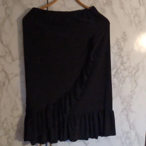 Svart kjol  - Svart kjol med volanger och resårkant i midjan 