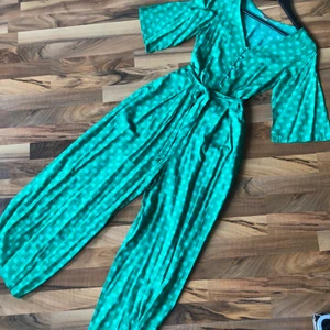 Monki Jumpsuit grön - Säljer denna fantastiska jumpsuit från monki. Ett av mina favoritplagg som tyvärr har blivit för litet. Storlek 32 men jag skulle säga att det är mer storlek 36(beroende på hur man vill att den ska sitta😉 välanvänd men i fint skick utan fläckar eller revor