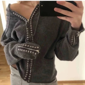 Zip hoodie - Grå zip hoodie med coola detaljer från hunkydory men nu köpt secondhand! Lånad första bild. Min är storleken mindre än första lånade bilden. Jag är en M/L för referens. Köp direkt för 400kr