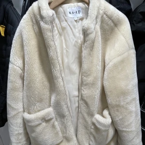 Mysig jacka  - Mysig, mjuk jacka i storlek 40. Två stora fickor. Jackan kan stängas mha dragkedja. Från märket NA-KD. Nypris på 500 kr, säljer för 150kr.