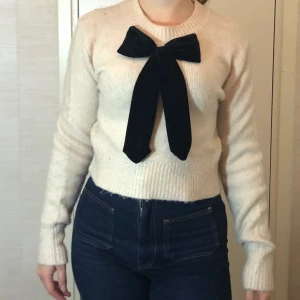 Tröja m rosett - Supersöt stickad tröja m svart sammetsrosett! Säljer för 85kr💕 