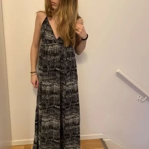 V-ringad långklänning  - Världens finaste låna klänning med V-ringning. Den är öppen i ryggen och har slits längst ned. Banden går att justera!