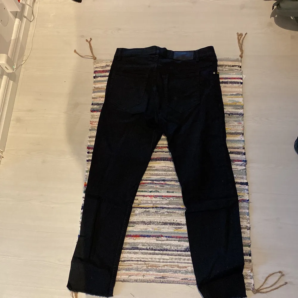 Svarta jeans i storlek 33/32, fransiga nertill. tajt modell.. Jeans & Byxor.