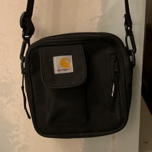 Carhartt Essentials Bag - Carhartt axelväska, knappt använd. Köpt för ett år sedan och bara hängt på en krok. Nyskick!