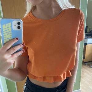 En orange T-shirt/topp från Gina tricot med detalj nertill. Köparen står för eventuell frakt! 