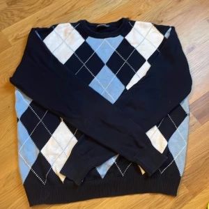 Stickad tröja från brandy Melville  - Rutig tröja från Brandy Melville! Baksidan och armarna är marinblå och framsidan rutig. Köparen står för frakt! 