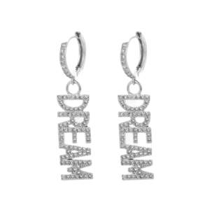 Material: Stainless Steel. Unveil the Dream Earrings by Bravery – a radiant dance of light, a testament to the power of dreams, each letter a sparkling beacon of hope, meticulously crafted with simulated diamonds.