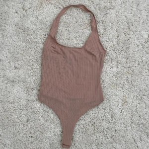 Topp - Snygg body, i färgen ljusrosa, bra skick